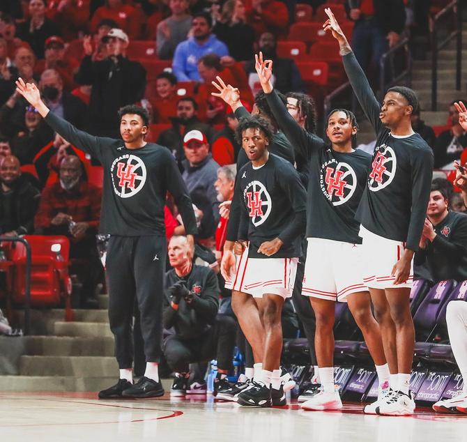 The No. 7 Houston men’s basketball team celebrates a made 3-pointer on the bench.