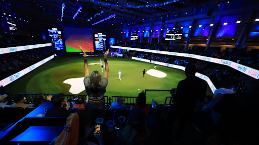 A fan cheers in the stands during play on the the ninth hole during the TGL presented by SoFi match between the New York Golf Club and The Bay Golf Club at SoFi Center on January 07, 2025 in Palm Beach Garden.