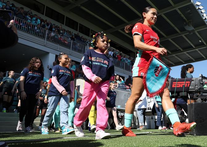 Lo'eau LaBonta #10 of the Kansas City Current leads the team onto the field prior to the inaugural match against the Portland Thorns FC at CPKC Stadium, the first stadium purpose-built for women's soccer, on March 16, 2024 in Kansas City, Missouri.