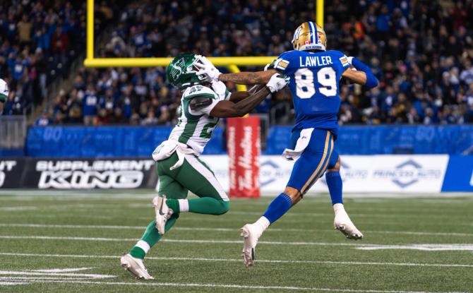 Winnipeg Blue Bombers wide receiver Kenny Lawler stiff arms a Saskatchewan Roughrider defender during the CFL’s West Division Finals.