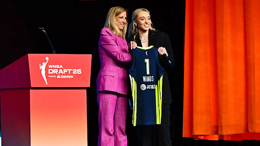 Paige Bueckers stands next to WNBA commissioner Cathy Engelbert after being drafted first overall at the 2025 WNBA Draft.