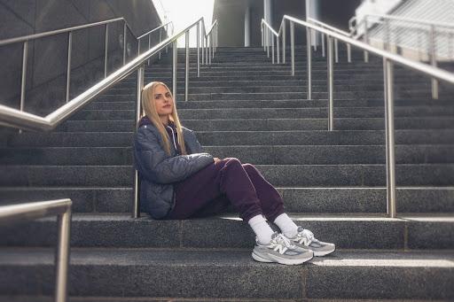 Parker Valby poses for a photo on stairs