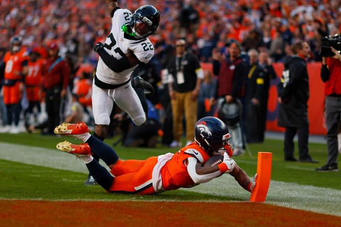 Denver Broncos running back R.J. Harvey dives into the end zone for a touchdown.