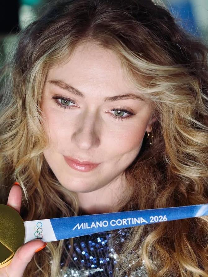 Mikaela Shiffrin poses with her gold medal from Milano Cortina 2026.