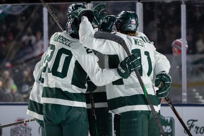 The No. 1 Michigan State Spartans celebrate after scoring a goal.