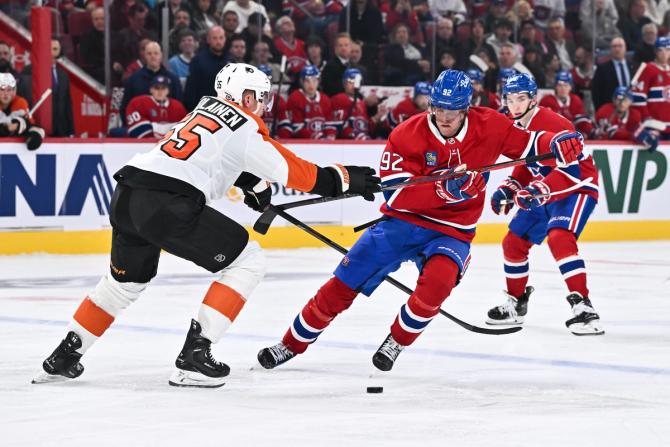 Patrik Laine #92 of the Montreal Canadiens skates the puck against Rasmus Ristolainen #55 of the Philadelphia Flyers