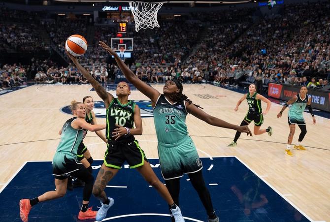Minnesota Lynx Courtney Williams is defended at the rim by NY Liberty forward Jonquel Jones.