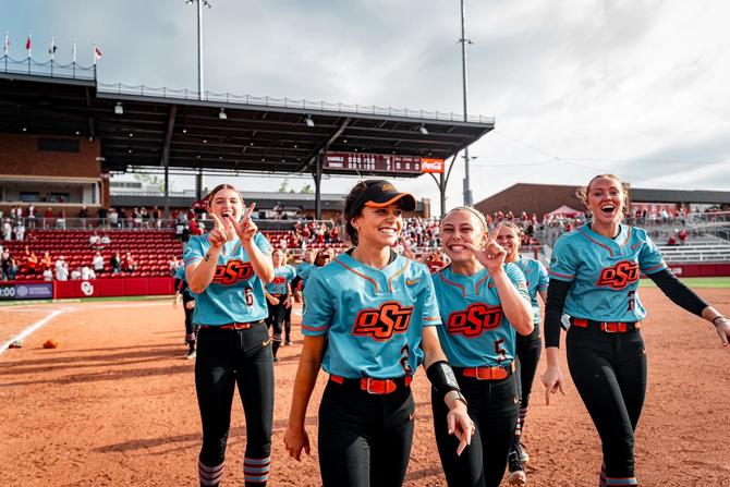 No. 2 Oklahoma State softball players smile as they leave the diamond following their huge series win over No. 4 Oklahoma on Saturday.