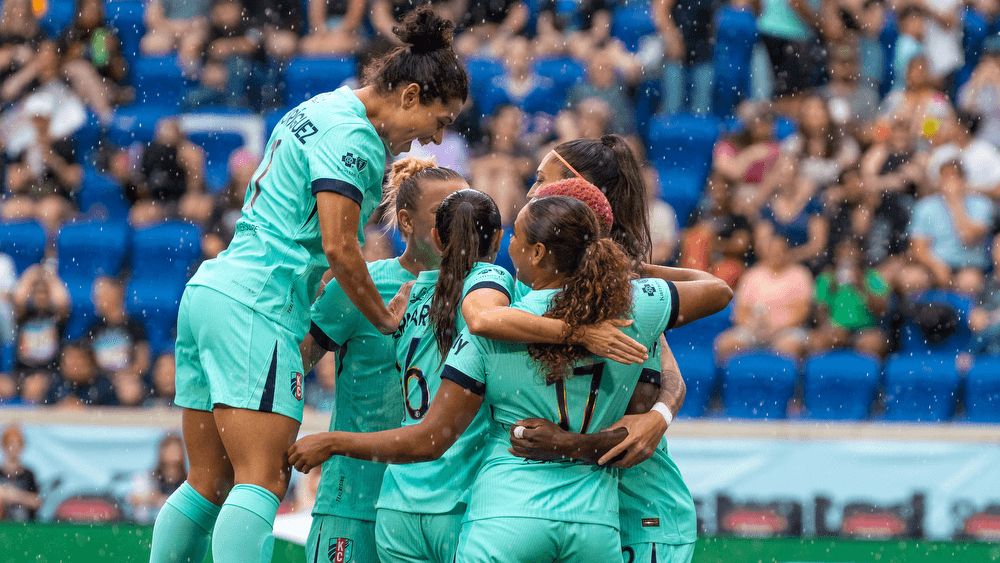 Kansas City Current celebrate after a goal. 