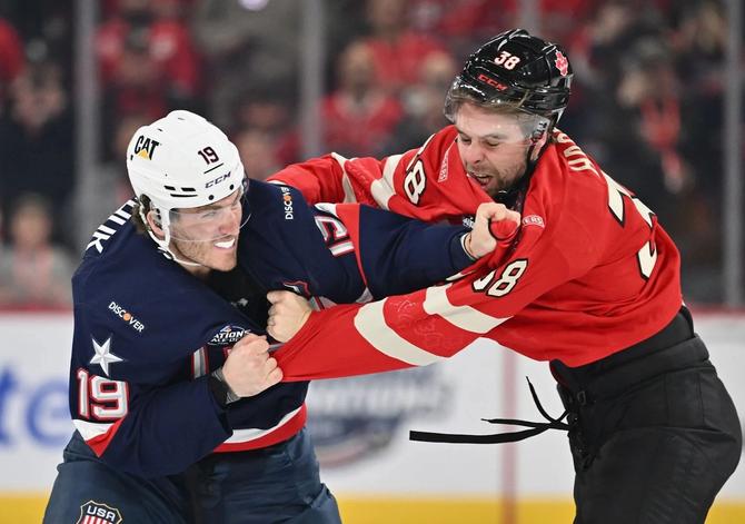 Matthew Tkachuk (left) of Team USA fights with Brandon Hagel of Team Canada in the opening seconds of their game Saturday.
