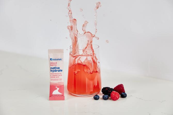 A package of NativePath hydration packets on display with fruits