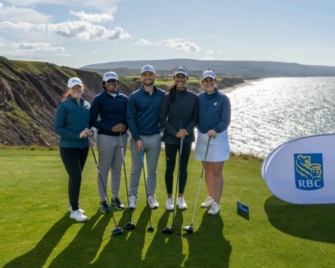 Five golfers posing at a hole during the RBC PGA scramble
