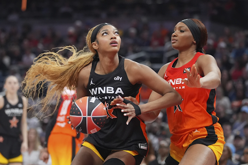 The Sky’s Angel Reese, left, shoots against Washington Mystics’ Kiki Iriafen during the second half of the WNBA All-Star Game, Saturday, July 19, 2025, in Indianapolis.