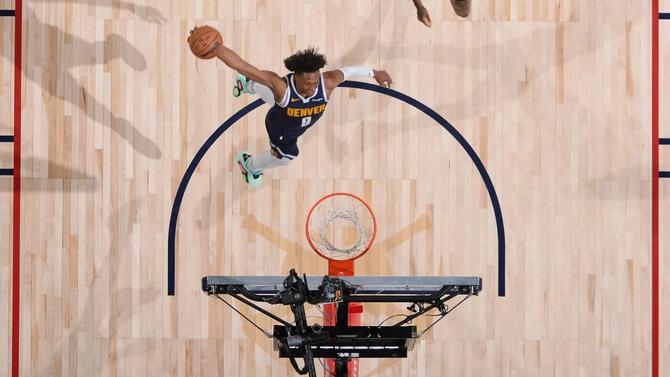 The Denver Nuggets Peyton Watson goes for a dunk.