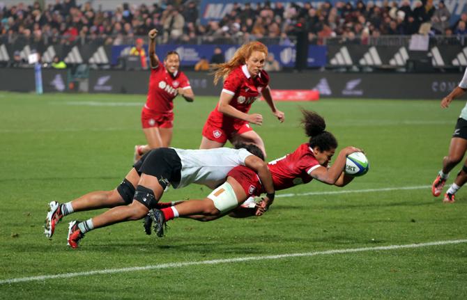 A Team Canada rugby player scoring a try