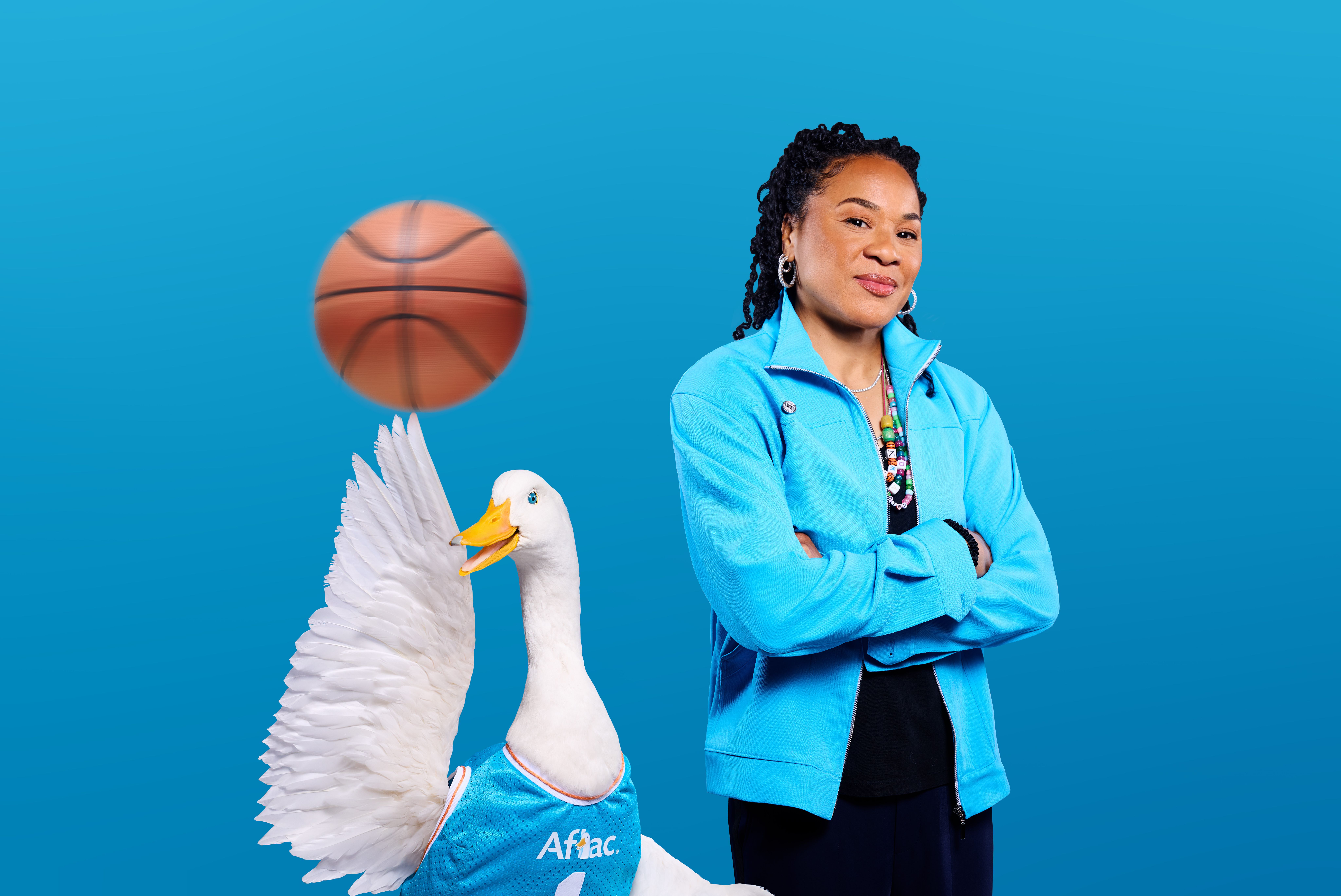 Dawn Staley posing with the Aflac duck