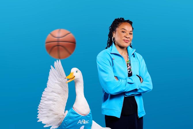 Dawn Staley posing with the Aflac duck