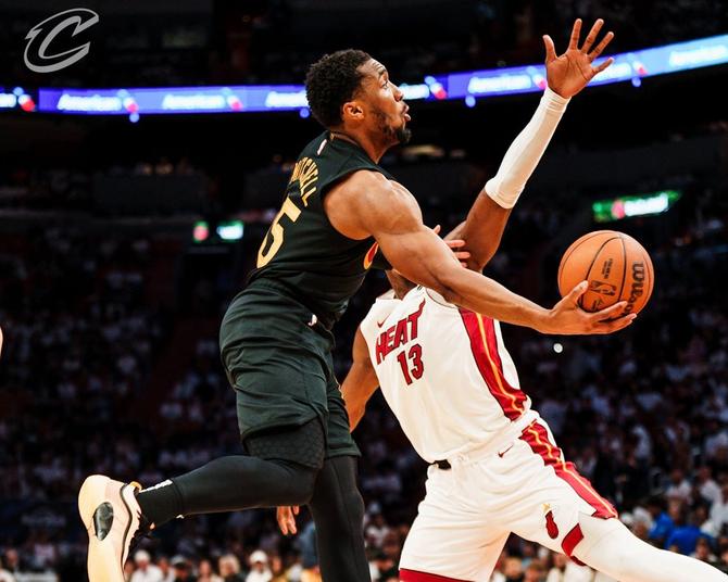 Cleveland Cavalier Donovan Mitchell attempts an acrobatic layup against the Miami Heat in the Cavs’ Game 4 win.