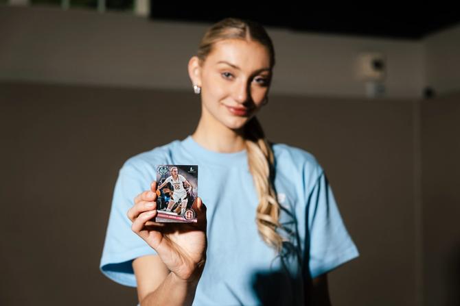 Cameron Brink holds her Topps Bowman U Chrome Basketball card towards the camera.