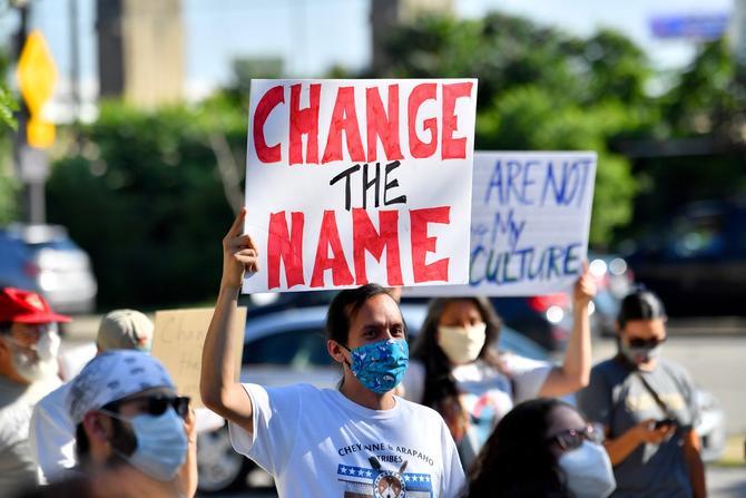 A group of protesters demonstrate against the Cleveland Indians mascot prior to the Opening Day game between the Cleveland Indians and the Kansas City Royals