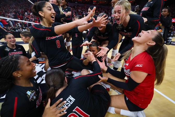 The Louisville volleyball team celebrates its semi final win over Pitt.