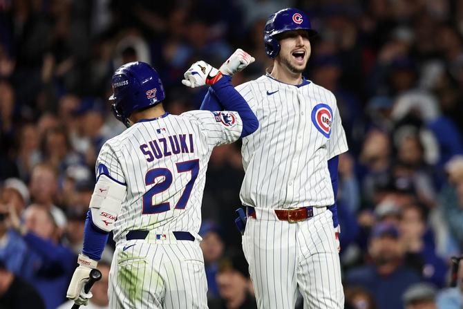 Seiya Suzuki #27 and Kyle Tucker #30 of the Chicago Cubs celebrate after Tucker hit a home run during the seventh inning against the Milwaukee Brewers