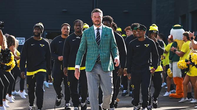 Head coach Dan Lanning leads the Oregon football team into their stadium before a game.