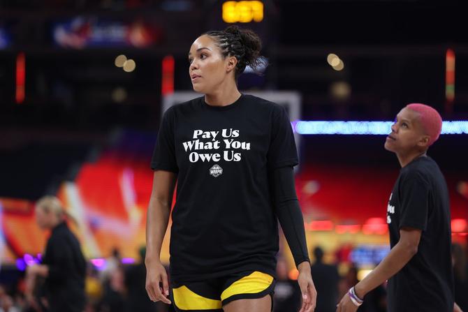 Napheesa Collier wears a t-shirt that says “Pay us what you owe us” before the WNBA All-Star Game on Saturday.