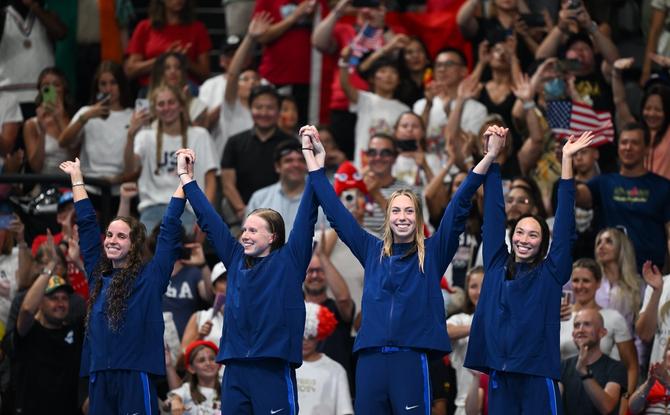 The Team United States relay team — Regan Smith, Lilly King, Gretchen Walshe, and Torri Huske — during the awards ceremony.