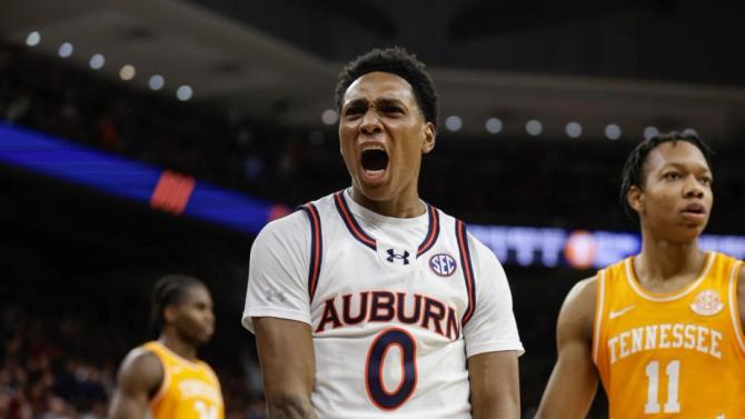 Auburn men’s basketball player Tahaad Pettiford flexes during a game against Tennessee.