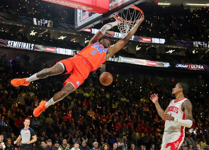 Jalen Williams of the Oklahoma City Thunder hands on the rim after he dunks during the NBA Cup semifinals.