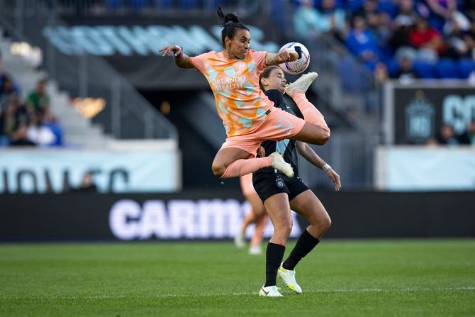 Marta #10 of Orlando Pride jumps and back kicks to keep control of the ball.