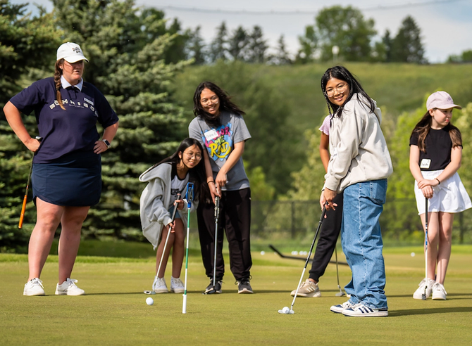 Kids trying golf on a golf course