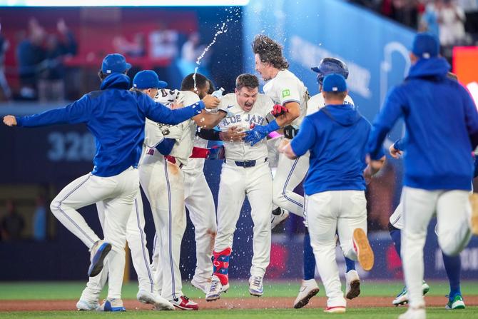 The Toronto Blue Jays celebrating their walk-off win on the field
