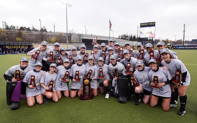 The Northwestern Wildcats pose with their championship trophies.