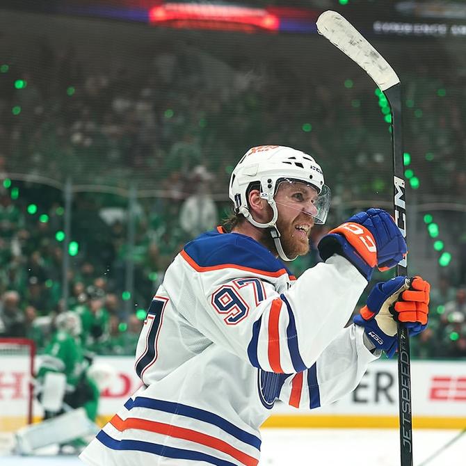 Connor McDavid celebrating while holding his hockey stick
