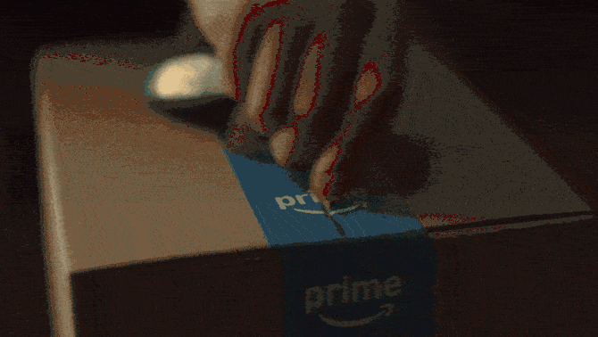 A man opens an Amazon box containing an string of lights for his truck bed, text reads "Date Night. Same-Day Delivery. It's on Prime"