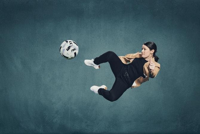 Diana Matheson kicking a soccer ball