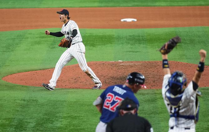 Shohei Ohtani celebrates after striking out Mike Trout