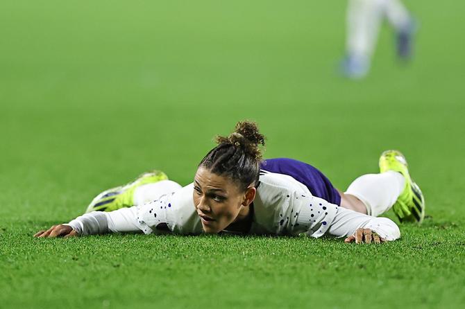 No. 2 USWNT forward Trinity Rodman lies on the pitch.