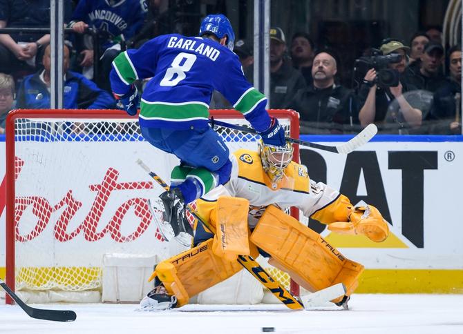 Conor Garland #8 of the Vancouver Canucks jumps in front of Juuse Saros #74 of the Nashville Predators during the 2nd period in Game Two of the First Round of the 2024 Stanley Cup Playoffs