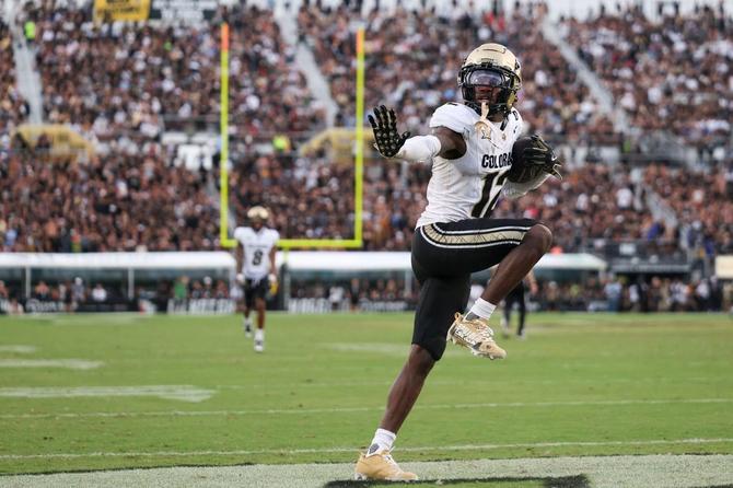 Colorado Buffalo Travis Hunter does the Heisman pose to celebrate an interception.