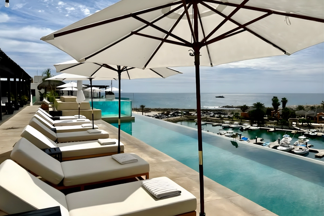 Lounge chairs in front of infinity pool.