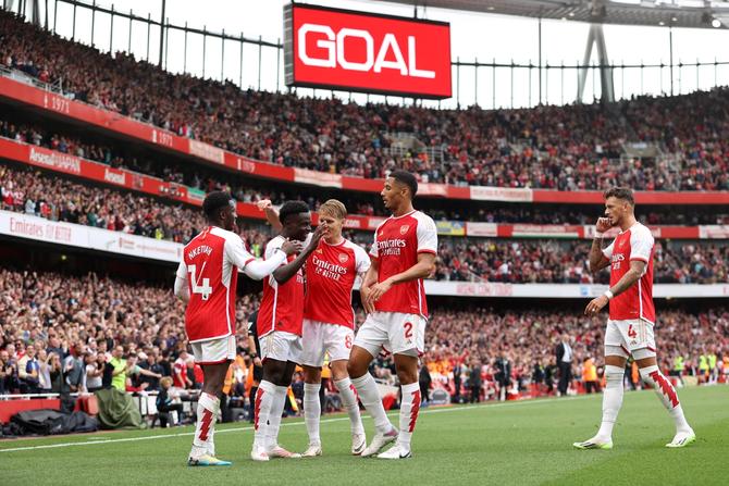 Bukayo Saka of Arsenal celebrates after an own goal during the Premier League match between Arsenal FC and Tottenham Hotspur at Emirates Stadium.
