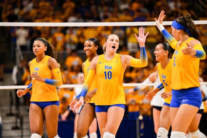 The Pitt volleyball team celebrates a point.