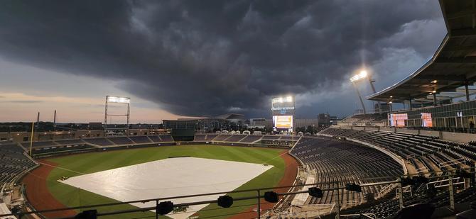 Dark clouds roll in over Charles Schwab Field, the home of the Men’s College World Series.