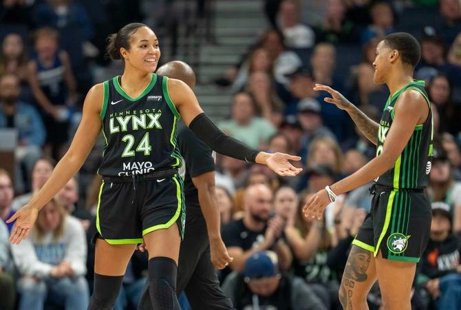 Minnesota Lynx Napheesa Collier high-fives her teammate Courtney Williams during a game.