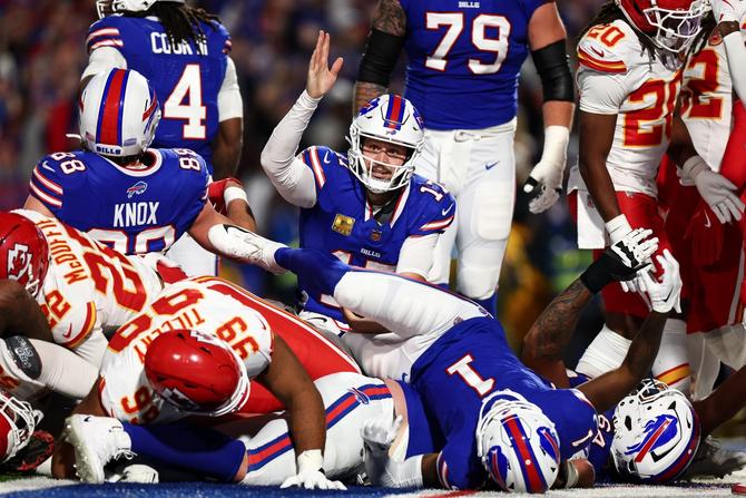 Buffalo Bills quarterback Josh Allen holds his hand up after scoring a touchdown against the Kansas City Chiefs.