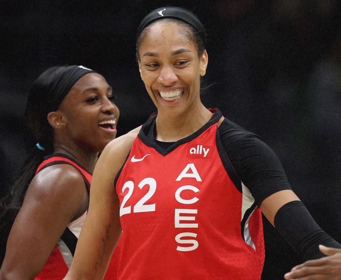 A'ja Wilson smiles and high-fives a teammate during last night's game against the Seattle Storm.