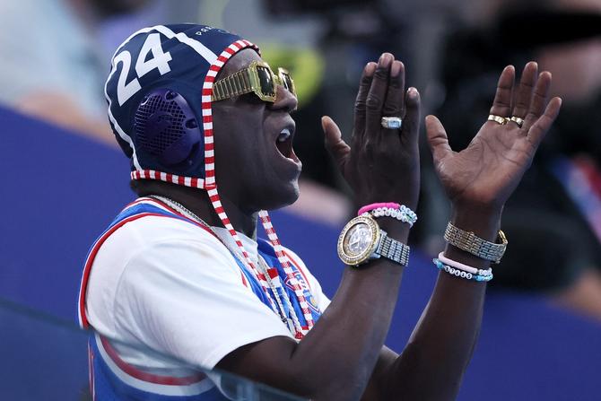 American rapper, Flavor Flav, shows his support during the Women's Preliminary Round Group B match between Team Italy and Team United States on day five of the Olympic Games Paris 2024 at Aquatics Centre on July 31, 2024 in Paris, France.